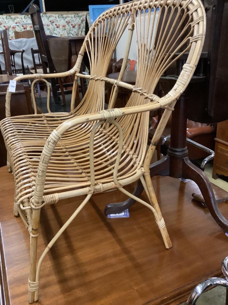 A 1970's bamboo and cane two seater conservatory settee, length 110cm, depth 52cm, height 97cm